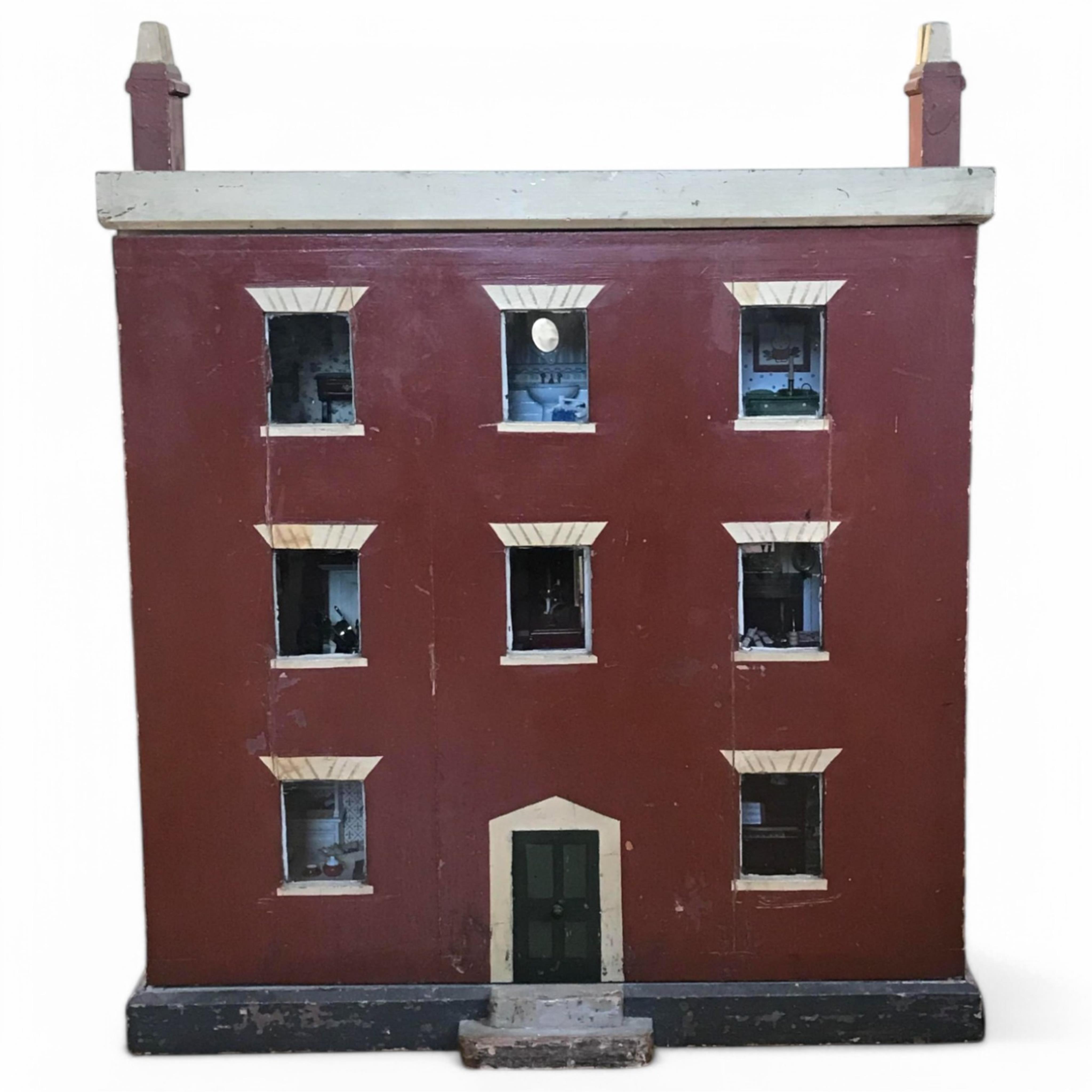 A late 19th century doll's house, with a single front opening panel, incorporating eight internal rooms, flat roof with parapet, dimensions 81.5cm high, 79cm wide, 30cm deep, together with modern manufactured furniture a